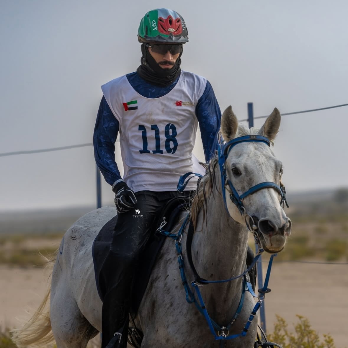 Rider number 118 on a grey horse