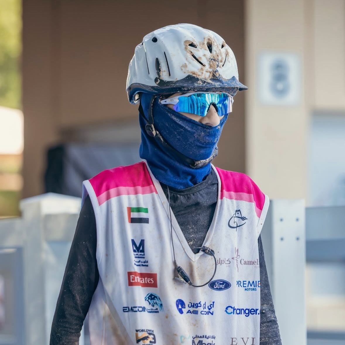 Endurance rider in a helmet, face mask and blue mirror sports sunglasses